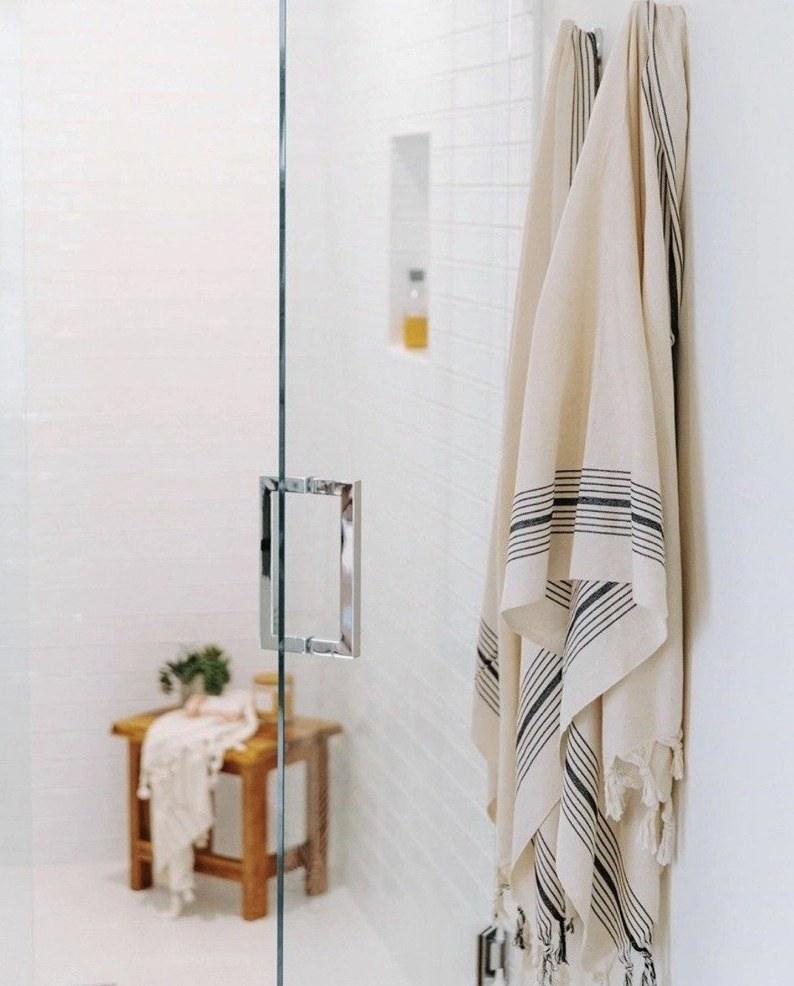 Turkish bath towel hanging by a shower