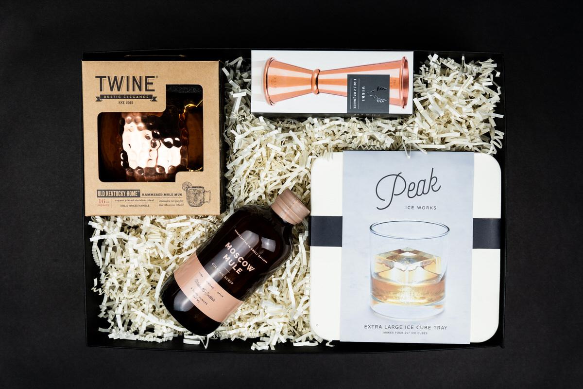Happy Hour box: copper mugs, a copper jigger, cocktail syrup, and a Peak ice tray