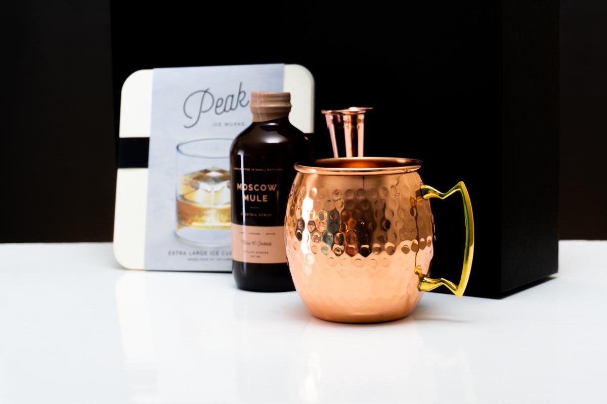 A hammered copper mule mug with the syrup and ice tray