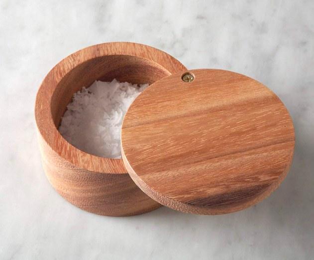 Acacia salt cellar with the lid swung open